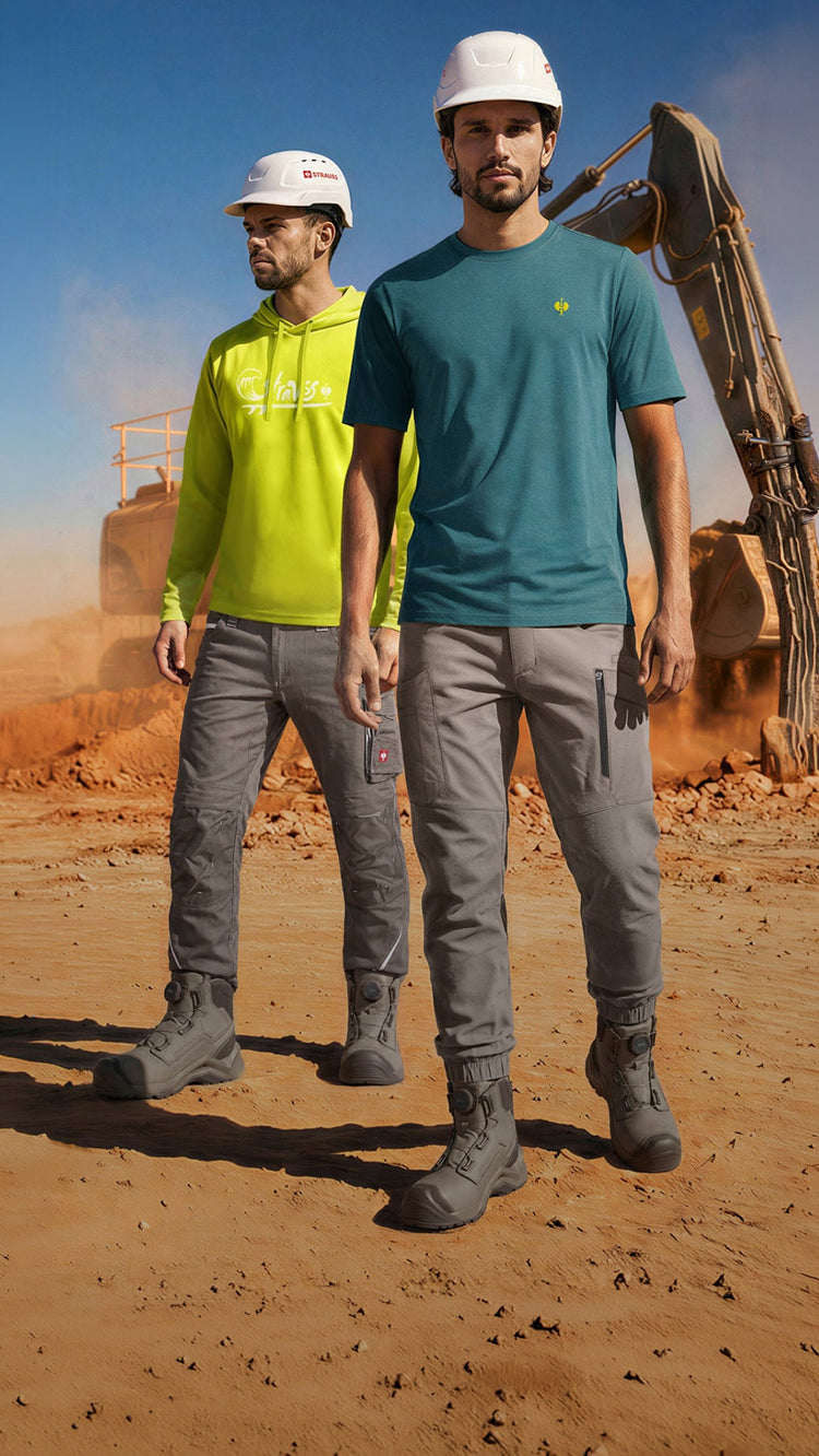 Two men stand in a jobsite wearing strauss workwear